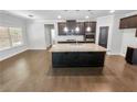 Modern kitchen with large island and hardwood floors at 3650 Lindsy Brooke Ct, Douglasville, GA 30135