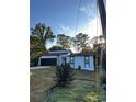 White house with black accents, newly landscaped lawn, and a two-car garage at 4907 Wycliffe Sw Dr, Stone Mountain, GA 30087