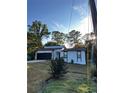 White house with black accents, newly landscaped lawn, and a two-car garage at 4907 Wycliffe Sw Dr, Stone Mountain, GA 30087