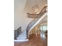 Elegant two-story staircase with wrought iron railing at 858 Middle Fork Trl, Suwanee, GA 30024