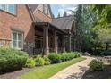 Brick home with a stone walkway leading to side porch at 858 Middle Fork Trl, Suwanee, GA 30024