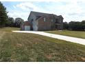 Two-story brick home with a detached garage and expansive backyard at 689 S Jeff Davis Dr, Fayetteville, GA 30215