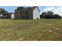 Two-story brick house with a large backyard and neighboring houses visible at 689 S Jeff Davis Dr, Fayetteville, GA 30215