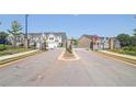 Gated community entrance with a paved road and landscaping at 174 Hampton Cir, Mcdonough, GA 30253