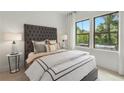Cozy bedroom with a tufted headboard and large windows at 1094 Battery Park Rd, Decatur, GA 30033