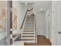 Bright entryway with staircase, hardwood floors, and a small console table at 1096 Battery Park Rd, Decatur, GA 30033