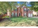 Two story brick house with a two car garage and large yard at 2049 Town Square Dr, Mcdonough, GA 30253