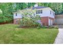 Two-story home with attached garage and spacious yard at 5163 Lakeside Dr, Dunwoody, GA 30360
