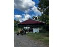 Metal storage shed with tractor and other equipment at 268 Arnold Mill Rd, Woodstock, GA 30188