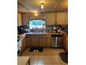 Kitchen with wooden cabinets, stainless steel appliances, and tile floor at 268 Arnold Mill Rd, Woodstock, GA 30188