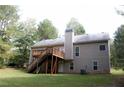 Two-story house with elevated deck, stairs and a large backyard at 7025 Fletcher Dr, Winston, GA 30187