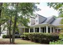 Two-story house with front porch, landscaping and partial view of neighborhood at 7025 Fletcher Dr, Winston, GA 30187