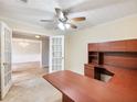 Home office with L-shaped desk, built-in hutch, and French doors at 2685 Angel Oak Cir, Dacula, GA 30019