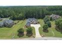 Luxury home nestled in a wooded lot with a large driveway at 309 Marbella Way, Mcdonough, GA 30252