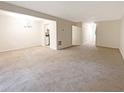 Large living room with neutral carpeting and access to the kitchen at 1206 Pine Tree Trl # 12C, Atlanta, GA 30349