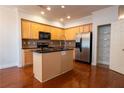 Kitchen with island, stainless steel appliances, and wood cabinets at 2986 Ashlyn Pointe Dr, Atlanta, GA 30340