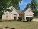 Charming brick home with a two-car garage and manicured lawn at 3475 Washington Rd, Atlanta, GA 30344