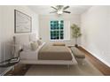 Main bedroom with large window, hardwood floors and neutral decor at 200 Renaissance Ne Pkwy # 302, Atlanta, GA 30308