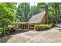 House with carport and landscaping, located on a hillside at 3154 Highway 155 N, Mcdonough, GA 30252