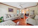 Spacious living room with hardwood floors, neutral furniture, and access to the dining area at 9334 Woodsboro Ct, Jonesboro, GA 30236