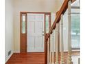 Inviting entryway with hardwood floors and staircase leading to upper levels at 9334 Woodsboro Ct, Jonesboro, GA 30236