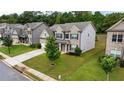 Two-story house with gray siding, brick accents, and a two-car garage at 1068 W Union Grove Cir, Auburn, GA 30011