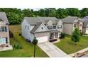 Two-story house with gray siding, brick accents, and a two-car garage at 1068 W Union Grove Cir, Auburn, GA 30011