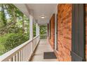 Long front porch with white railings and view of trees at 2550 Bentbrook Dr, Dunwoody, GA 30360