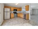 Kitchen with wood cabinets, stainless steel appliances, and tile floor at 65 Randall Dr, Rockmart, GA 30153