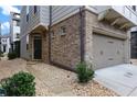 Brick and siding townhome with a two-car garage and stone walkway at 1062 Kirkland Cir, Smyrna, GA 30080