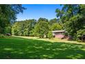 Spacious backyard with lush lawn and wooded backdrop at 725 Holland Rd, Powder Springs, GA 30127