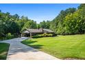 House with carport, long driveway, and expansive lawn at 725 Holland Rd, Powder Springs, GA 30127