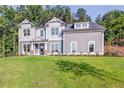 Two story gray house with white accents and green lawn at 200 Etris Grove Ct, Roswell, GA 30075