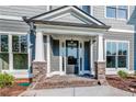 Front entrance with brick columns and a glass door at 200 Etris Grove Ct, Roswell, GA 30075