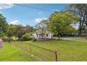 White house with front porch and fenced yard at 5665 Austell Powder Springs Rd, Austell, GA 30106