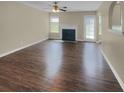 Living room with fireplace, dark wood floors, and sliding door access at 7458 Spoleto Loop, Fairburn, GA 30213