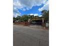 Yellow house with brick fence and gated driveway at 678 Quillian Ave, Decatur, GA 30032
