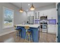 Modern kitchen with blue island and breakfast bar at 975 Welch Sw St, Atlanta, GA 30310