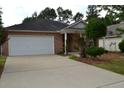 Brick ranch house with attached garage and neat landscaping at 1007 Sycamore Ln, Villa Rica, GA 30180