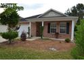 Brick ranch house with a covered porch and well-manicured landscaping at 1007 Sycamore Ln, Villa Rica, GA 30180