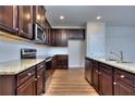 Modern kitchen with granite countertops, stainless steel appliances, and dark wood cabinets at 3405 Ripple Loop # 127, South Fulton, GA 30349