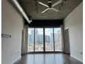 Living room with hardwood floors and sliding doors to balcony at 923 Peachtree Ne St # 830, Atlanta, GA 30309