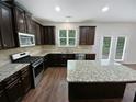 Modern kitchen featuring granite countertops and stainless steel appliances at 368 Madison Grace Ave, Mcdonough, GA 30252