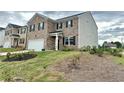 Two-story brick home with a two-car garage and landscaped yard at 2149 Redfern Rd, Dacula, GA 30019