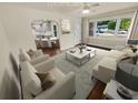 Virtually staged living room with hardwood floors and a view of the kitchen at 1955 S Columbia Pl, Decatur, GA 30032