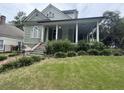 Two story green house with a large porch at 490 Hill Se St, Atlanta, GA 30312