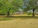 Charming ranch home nestled among mature trees at 1152 Harbins Rd, Dacula, GA 30019