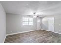 Bright living room featuring gray walls, wood-look floors and ceiling fan at 1669 Freedom Vly, Decatur, GA 30032