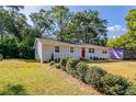 Newly renovated light gray house with red door and landscaping at 1669 Freedom Vly, Decatur, GA 30032