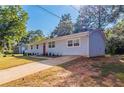 Newly renovated light blue house with red door, driveway and landscaping at 1669 Freedom Vly, Decatur, GA 30032